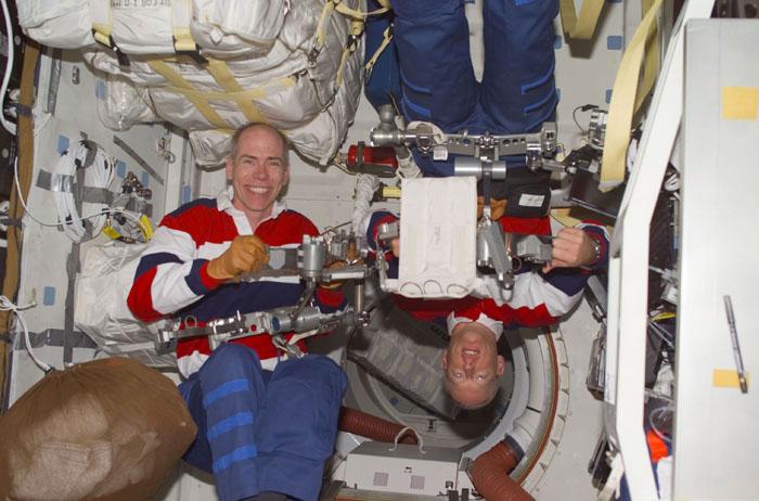 STS105-E-5214 (15 August 2001) --- Astronauts Daniel T. Barry (left) and  Patrick G. Forrester check out some of the equipment they will be working with  on their scheduled space walk in less than 24 hours.  The image was recorded with a digital still camera.