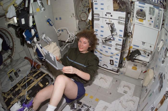 STS105-E-5226 (16 August 2001) --- Now a member of the STS-105 crew, departing  Expedition Two flight engineer Susan J. Helms works out on the ergometer device on the mid deck of the Space Shuttle Discovery. The image was recorded with a digital still camera.