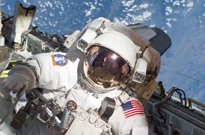 STS105-E-5233 (16 August 2001) ---  The helmet and torso of astronaut Patrick G. Forrester are featured in this digital still camera's view recorded during early stages of the first space walk on STS-105. Most of the cargo bay of the Space Shuttle Discovery and the aft cabin is reflected in the helmet visor.