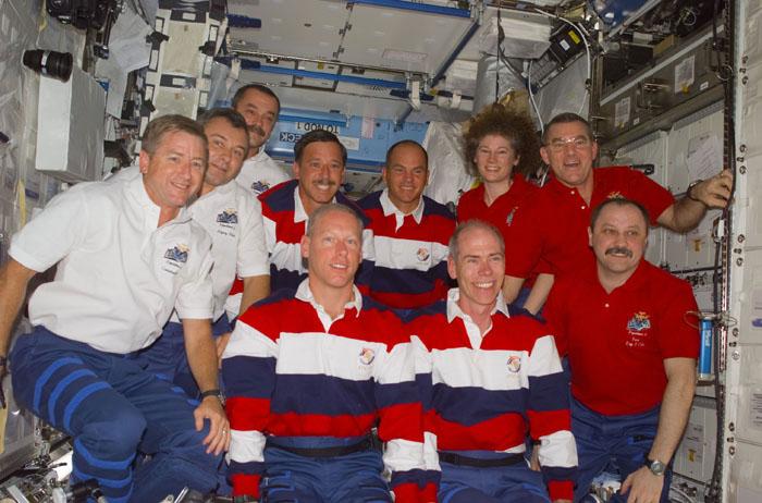 STS105-E-5326 (17 August 2001) --- The Expedition Three (white shirts), STS-105 (striped shirts), and Expedition Two (red shirts) crews assemble for a press conference in the U.S. Laboratory. The Expedition Three crew members are, from front to back, Frank L. Culbertson, mission commander;  and cosmonauts Vladimir N. Dezhurov and Mikhail Tyurin, flight engineers; STS-105 crewmembers are, front row, Patrick G. Forrester and Daniel T. Barry, mission specialists, and back row, Scott J. Horowitz, commander, and Frederick W. (Rick) Sturckow, pilot; Expedition Two crewmembers are, from front to back, cosmonaut Yury V. Usachev, mission commander, and James S. Voss and Susan J. Helms, flight engineers. This image was taken with a digital still camera.