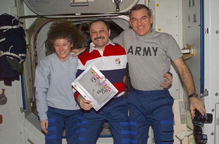 STS105-E-5383 (20 August 2001) --- The Expedition Two crewmembers, Susan J. Helms (left), flight engineer, cosmonaut Yury V. Usachev, mission commander, and James S. Voss, flight engineer, pose in Unity Node 1 for their final group photograph aboard the International Space Station (ISS).  With the arrival of Expedition Three, Usachev, Helms and Voss will return to Earth with the STS-105 crew thus completing their five month mission.  This image was taken with a digital still camera.