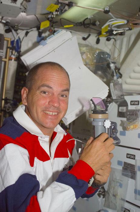 STS105-E-5414 (20 August 2001) --- Astronaut Frederick W. Sturckow, STS-105 pilot, handles the Co-Axial Sight (COAS) on the mid deck of the Space Shuttle Discovery.  This image was taken with a digital still camera.