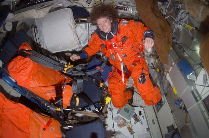STS105-E-5438 (21 August 2001) --- Astronaut Susan J. Helms, Expedition Two flight engineer, is dressed in her Launch and Entry Suit (LES) on the mid deck of the Space Shuttle Discovery in preparation for the descent back to Earth.  Helms and fellow Expedition Two crew members James S. Voss and cosmonaut Yury V. Usachev are returning to Earth after completing their five month mission aboard the International Space Station (ISS).  This image was taken with a digital still camera.