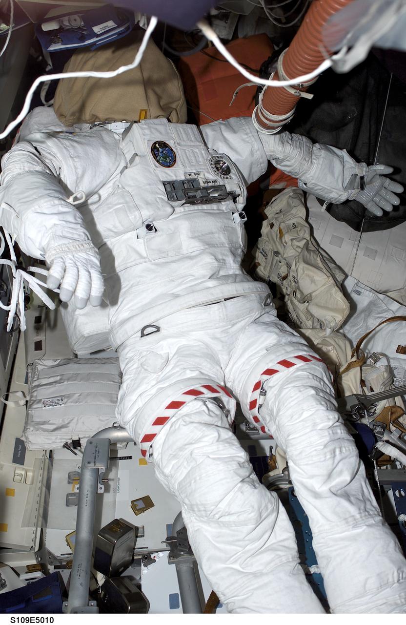 STS109-E-5010 (3 March 2002) --- On the mid deck of the Space Shuttle Columbia, the extravehicular mobility unit (EMU) space suit for astronaut Michael J. Massimino, mission specialist, appears ready for duty.  The suit will be initially called on for support on the second day of extravehicular activity (EVA), as the second pair of STS-109 space walking astronauts gets into the act of working on the Hubble Space Telescope. The image was recorded with a digital still camera.