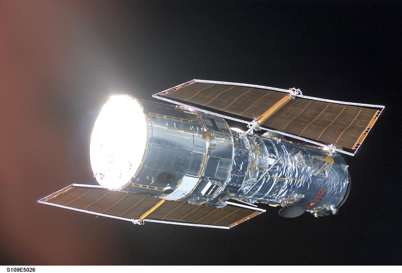 STS109-E-5026 (3 March 2002)  ---  The Hubble Space Telescope is backdropped against black space as the Space Shuttle Columbia, with a crew of seven astronauts on board, eases closer and closer in order to latch its 50-foot-long robotic arm onto a fixture on the giant telescope. As Columbia flew 350 miles above the Pacific Ocean Southwest of Mexico, with astronaut Nancy J. Currie, mission specialist, in control of the arm and astronaut Scott D. Altman, mission commander, at the  controls of the shuttle, the crew went on to capture the Hubble. The image was one of a series recorded with a digital still camera.