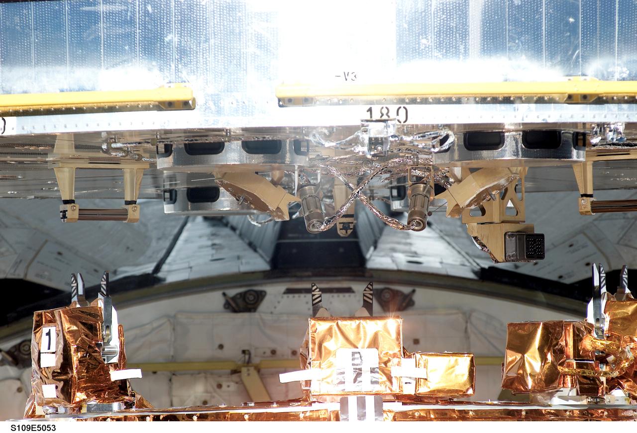 STS109-E-5053 (3 March 2002) --- The base of the Hubble Space Telescope is latched down on a special support structure in the cargo bay of the Space Shuttle Columbia. The bay's Flight Support System, as the structure (partially visible at bottom frame) is called, will hold the telescope for the next week, turning and tilting it as needed for the spacewalking work. Astronaut Nancy J. Currie, mission specialist, was in control of the Shuttle's remote manipulator system (RMS) robotic arm and astronaut Scott D. Altman, mission commander, was at the controls of the shuttle. The crew used a digital still camera to record a series of images documenting the fourth docking of a shuttle to the giant telescope during its tenure in space.