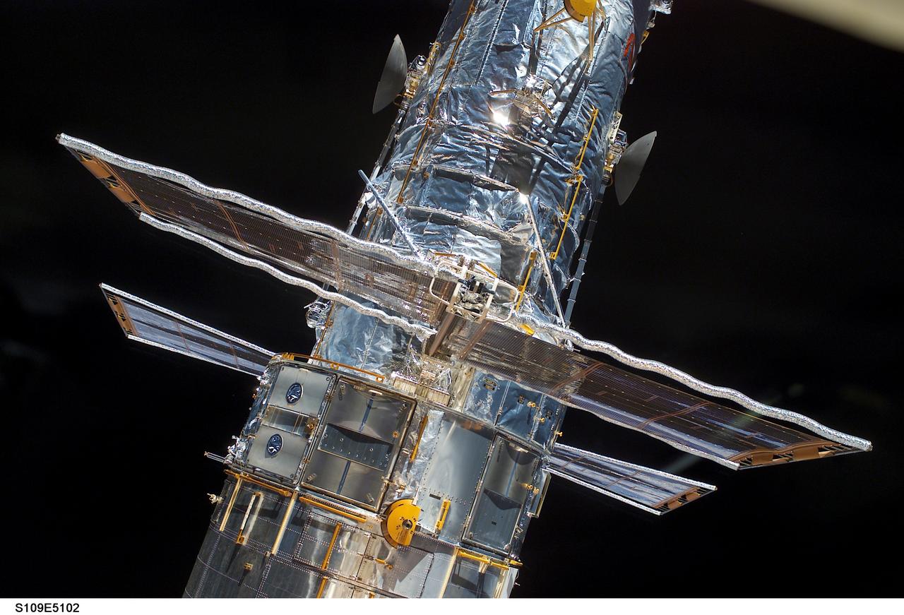 STS109-E-5102 (3 March 2002) --- The  Hubble Space Telescope is seen in the  cargo bay of the Space Shuttle Columbia.  Each present set of solar array panels will be replaced during one of the space walks planned for the coming week. The crew aimed various cameras, including the digital still camera used for this frame, out the shuttle's aft flight deck windows to take a series of survey type photos, the first close-up images of the telescope since December of 1999.