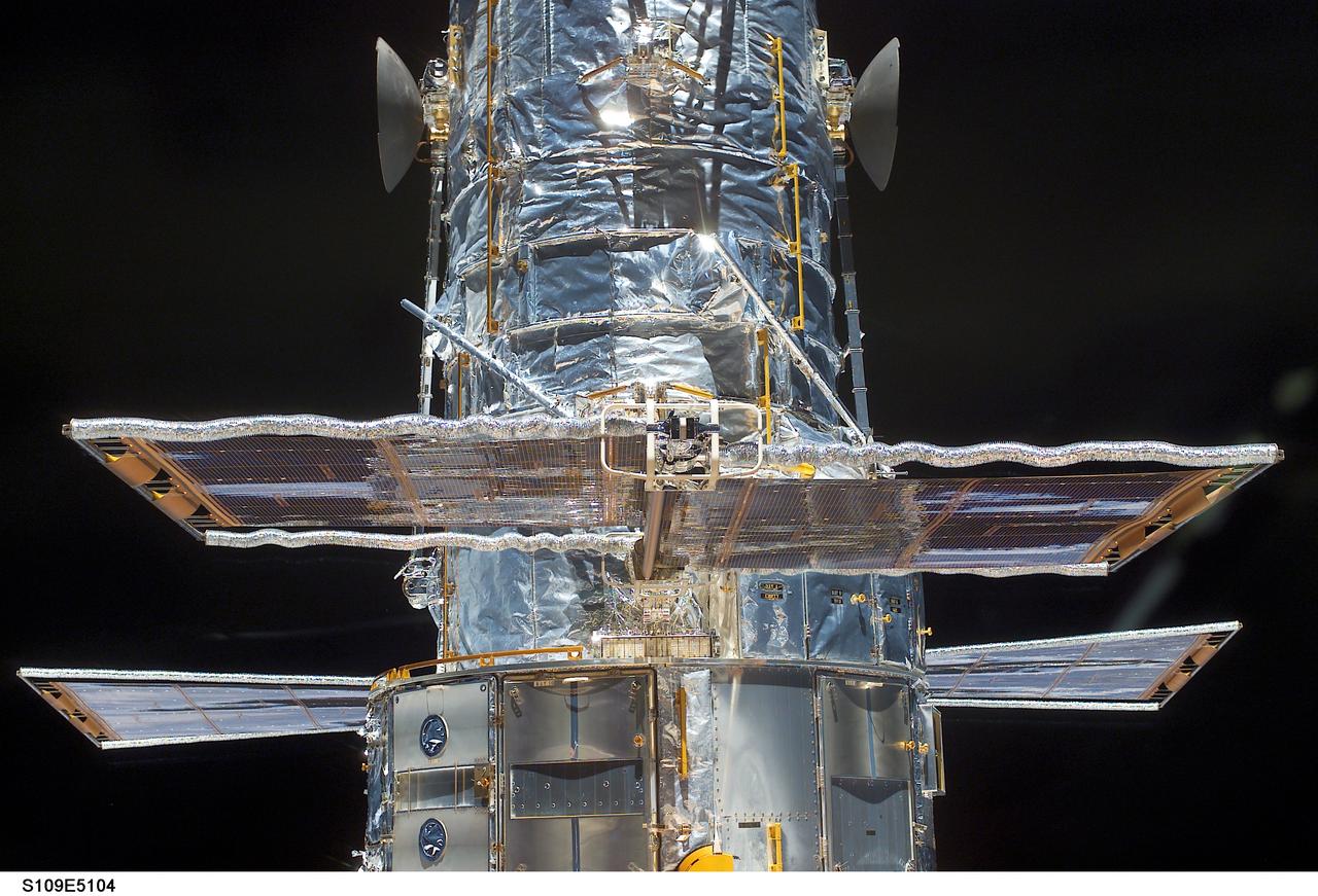 STS109-E-5104 (3 March 2002) --- The  Hubble Space Telescope is seen in the  cargo bay of the Space Shuttle Columbia.  Each present set of solar array panels will be replaced during one of the space walks planned for the coming week. The crew aimed various cameras, including the digital still camera used for this frame, out the shuttle's aft flight deck windows to take a series of survey type photos, the first close-up images of the telescope since December of 1999.