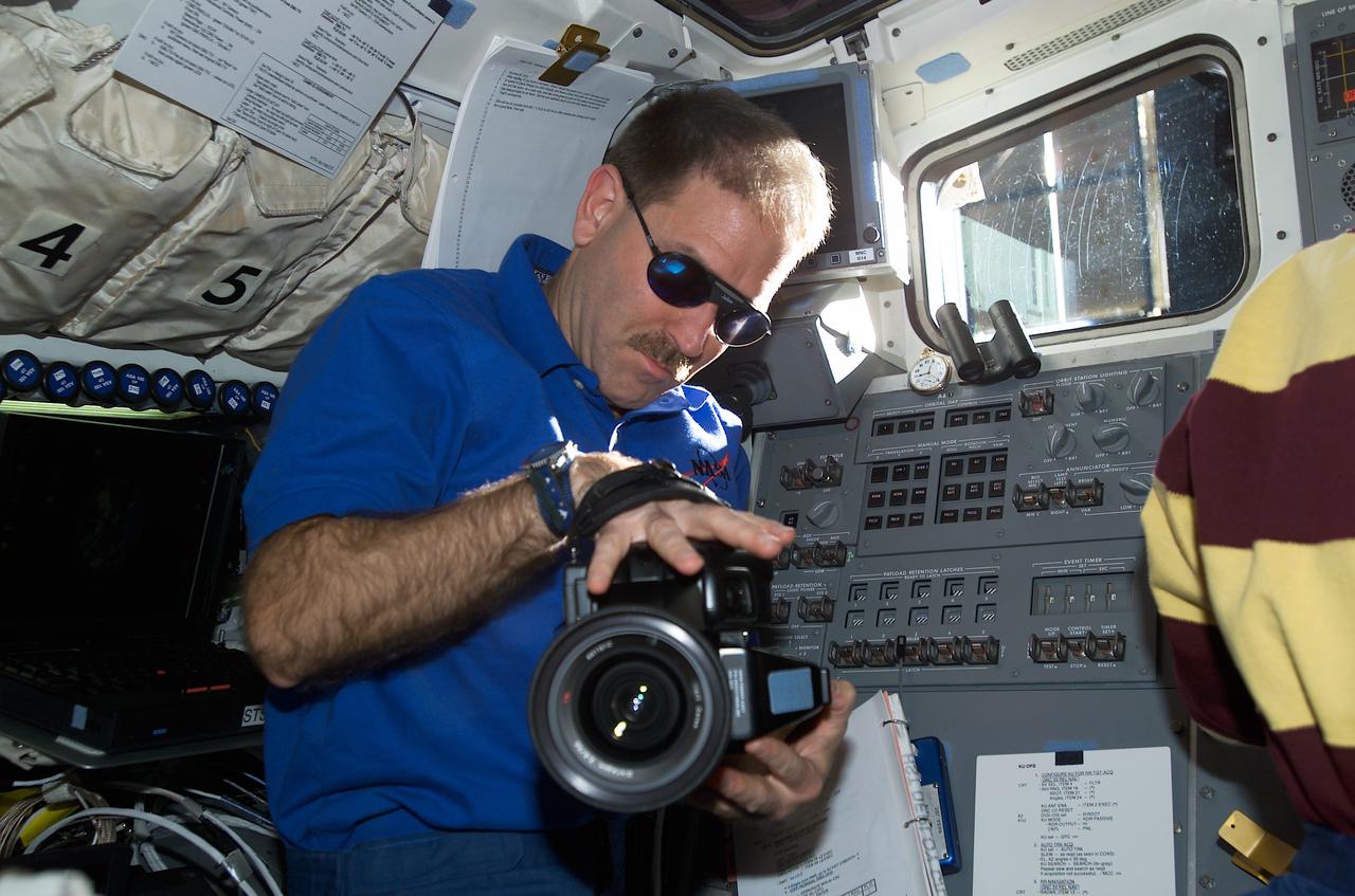 STS109-E-5904 (9 March 2002) --- Astronaut John M. Grunsfeld, STS-109 payload commander, holds a camera on the aft flight deck of the Space Shuttle Columbia. The image was recorded with a digital still camera.