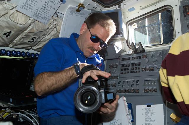 NASA image: MS Grunsfeld on flight deck with video camera