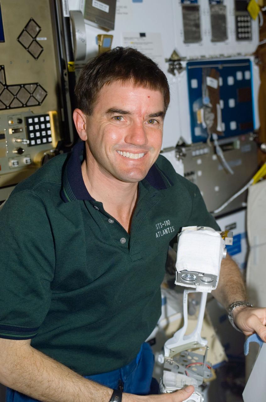 STS110-E-5006 (8 April 2002) --- Astronaut Rex J. Walheim, STS-110 mission specialist, works on the mid deck of the Space Shuttle Atlantis. The image was taken with at digital still camera.