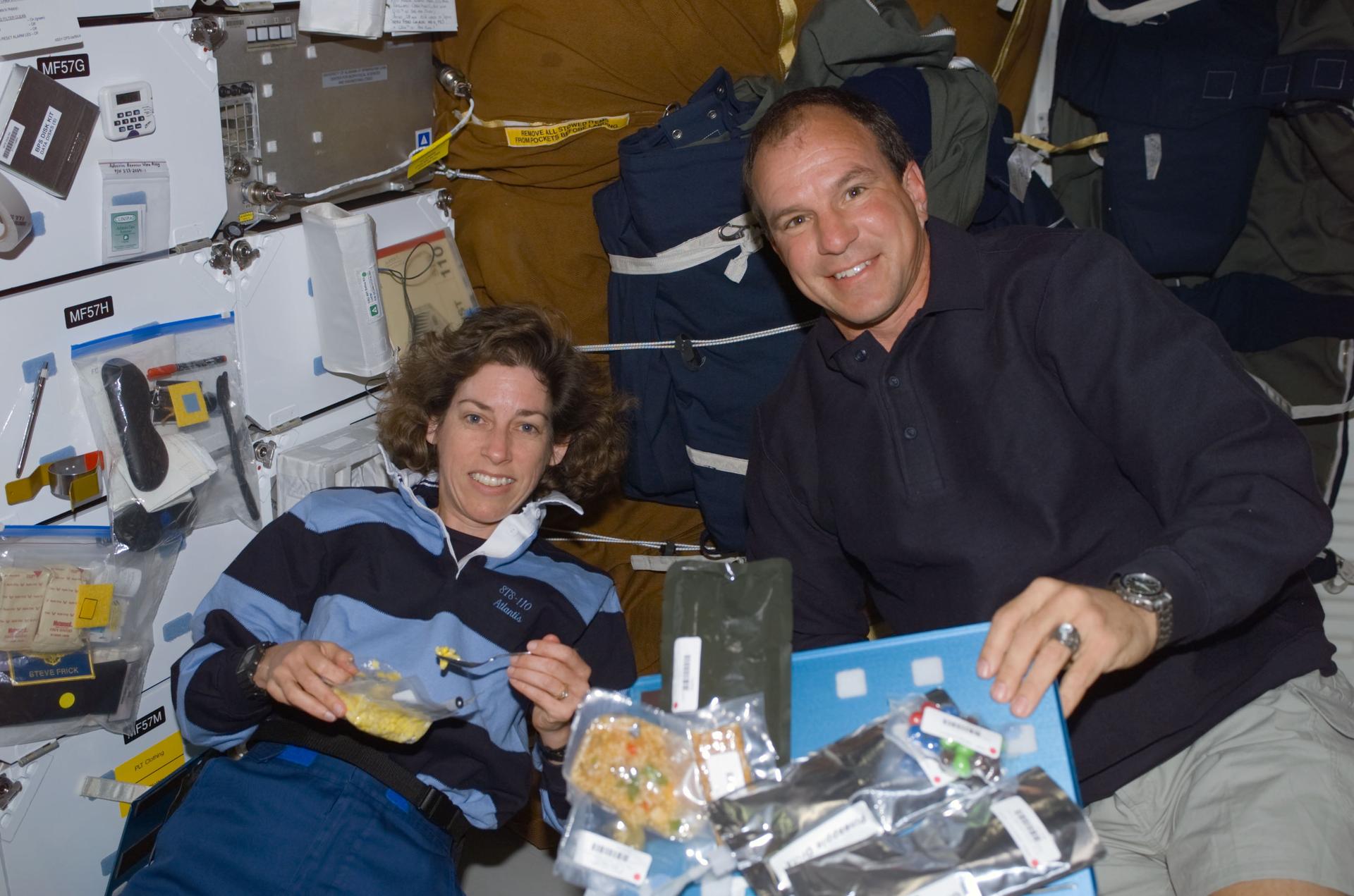 Ellen Ochoa and STS-110 mission commander Michael Bloomfield floating on the middeck on Atlantis