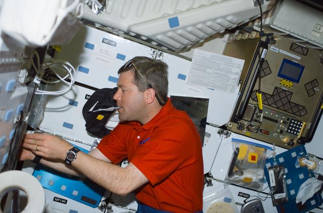 NASA image: Pilot Frick gets a drink at the galley on the middeck of Atlantis during STS-110