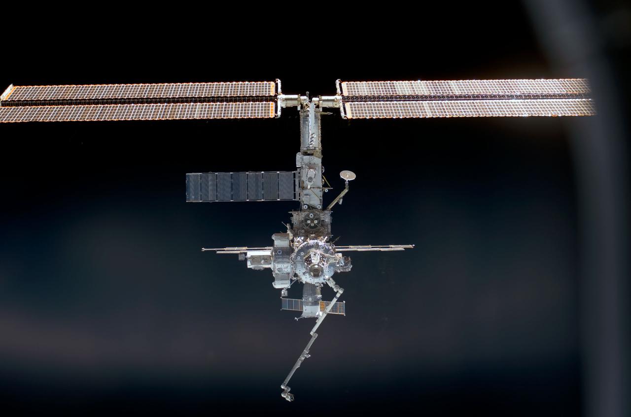 STS110-E-5075 (9 April 2002) --- Backdropped by the blackness of space, this full view of the International Space Station (ISS) was photographed by a STS-110 crewmember with a digital still camera during the docking approach.