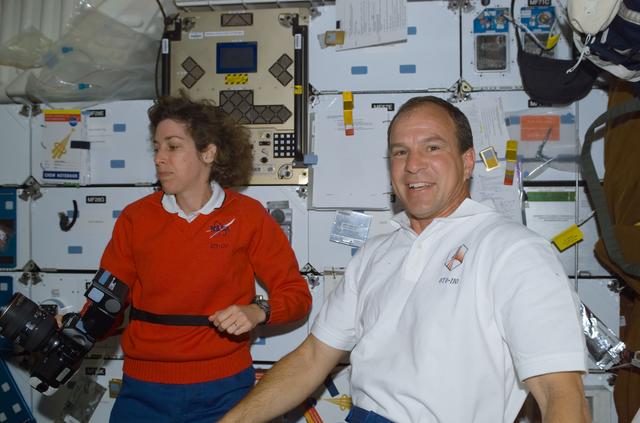 NASA image: Commander Bloomfield and MS Ochoa pose on the middeck of Atlantis during STS-110