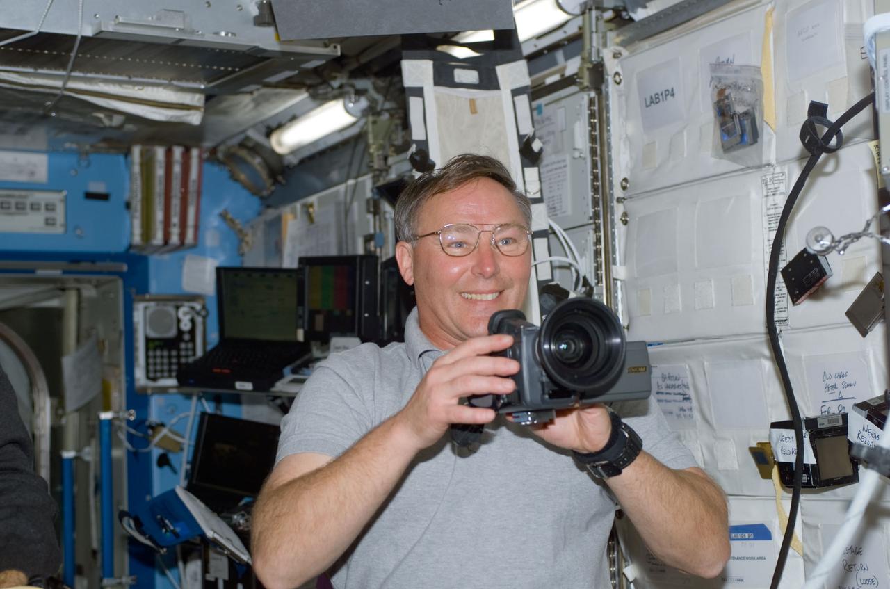STS110-E-5110 (10 April 2002) --- Astronaut Jerry L. Ross, STS-110 mission specialist, holds a still camera in the Destiny laboratory on the International Space Station (ISS). The image was taken with a digital still camera.