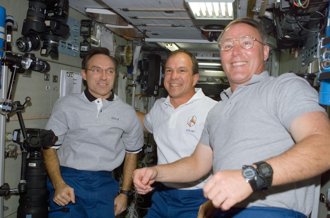 STS110-E-5126 (10 April 2002) --- Astronauts Carl E. Walz (left), Expedition Four flight engineer, Michael J. Bloomfield and Jerry L. Ross, STS-110 mission commander and mission specialist, respectively, are photographed in the Zvezda Service Module on the International Space Station (ISS). The image was taken with a digital still camera.