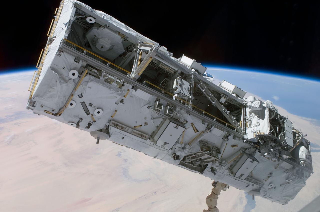 STS110-E-5172 (11 April 2002) --- Backdropped by the blackness of space and Earth&#0146;s horizon, the S0 (S-Zero) Truss is moved from the Space Shuttle Atlantis&#0146; cargo bay. Astronauts Ellen Ochoa, STS-110 mission specialist, and Daniel W. Bursch, Expedition Four flight engineer, used the International Space Station&#0146;s (ISS) Canadarm2 to lift the S0 Truss out of the orbiter&#0146;s payload bay and install it onto the temporary claw fixture on the Destiny laboratory. The image was taken with a digital still camera.
