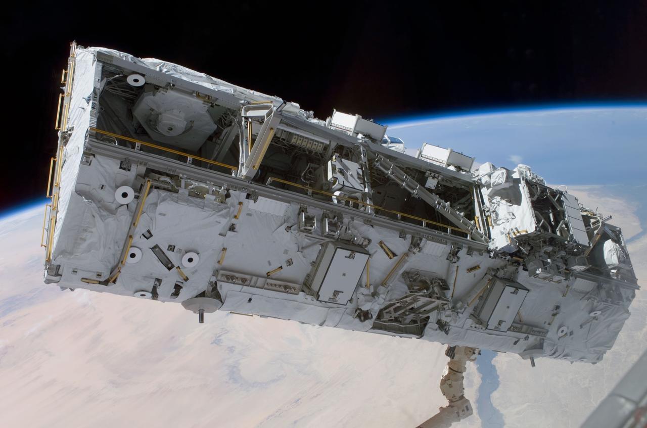 STS110-E-5173 (11 April 2002) --- Backdropped by the blackness of space and Earth&#0146;s horizon, the S0 (S-Zero) Truss is moved from the Space Shuttle Atlantis&#0146; cargo bay. Astronauts Ellen Ochoa, STS-110 mission specialist, and Daniel W. Bursch, Expedition Four flight engineer, used the International Space Station&#0146;s (ISS) Canadarm2 to lift the S0 Truss out of the orbiter&#0146;s payload bay and install it onto the temporary claw fixture on the Destiny laboratory. The image was taken with a digital still camera.