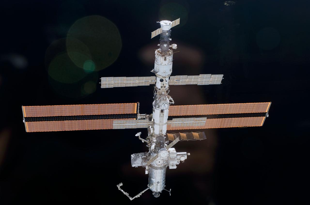 STS110-E-5918 (17 April 2002) --- This is one a series of digital still images of the International Space Station (ISS) recorded by the STS-110 crew members on board the Space Shuttle Atlantis following the undocking of the two spacecraft some 247 statute miles above the North Atlantic. Atlantis pulled away from the complex at 1:31 p.m. (CDT). After more than a week of joint operations between the shuttle and station crews, astronaut Stephen N. Frick, pilot, backed Atlantis away to a distance of about 400 feet in front of the station, where he began a 1 1/4 lap flyaround of the ISS, newly equipped with the 27,000 pound S0 (S-zero) truss, visible in this series of images. S0 is the first segment of a truss structure which will ultimately expand the station to the length of a football field.