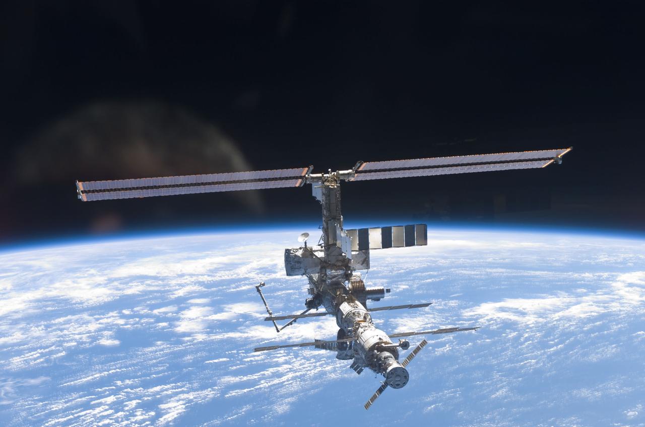 STS110-E-6058 (17 April 2002) --- This is one a series of digital still images of the International Space Station (ISS) recorded by the STS-110 crew members on board the Space Shuttle Atlantis following the undocking of the two spacecraft some 247 statute miles above the North Atlantic. Atlantis pulled away from the complex at 1:31 p.m. (CDT). After more than a week of joint operations between the shuttle and station crews, astronaut Stephen N. Frick, pilot, backed Atlantis away to a distance of about 400 feet in front of the station, where he began a 1 1/4 lap flyaround of the ISS, newly equipped with the 27,000 pound S0 (S-zero) truss, visible in this series of images. S0 is the first segment of a truss structure which will ultimately expand the station to the length of a football field.