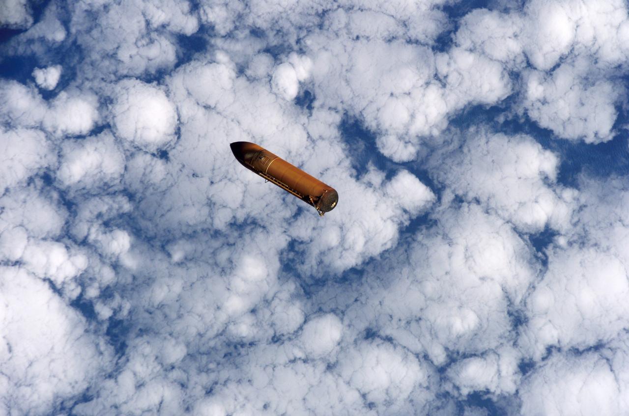 S114-E-5122 (26 July 2005) --- The external fuel tank is jettisoned from the Space Shuttle Discovery and falls toward Earth&#0146;s atmosphere during the completion of the launch phase of the STS-114 mission.  A blue and white Earth forms the backdrop for this image.