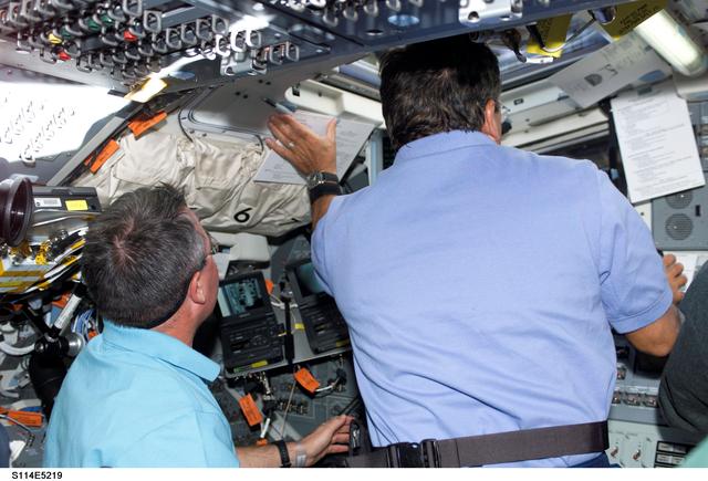 NASA image: STS-114 Mission specialists Robinson and Camarda on aft flight deck.