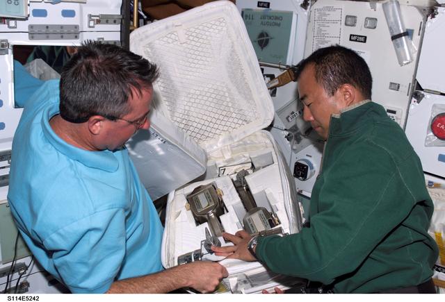 NASA image: STS-114 Mission specialists Noguchi and Robinson on middeck