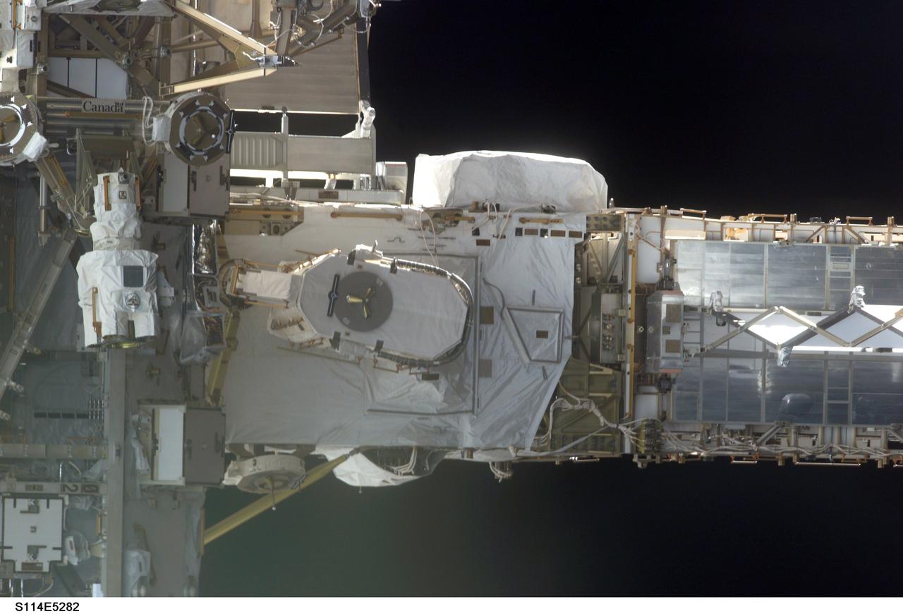 STS114-E-5282 (28 July 2005) --- This frame and STS114-E-5283 actually can be conjoined and rotated 90 degrees to make a single frame, providing an "astronaut's eye view" from Discovery's aft cabin looking toward the recently docked International Space Station.  At the left side are the S0 truss and mobile transporter, with the P6 truss on the right side.