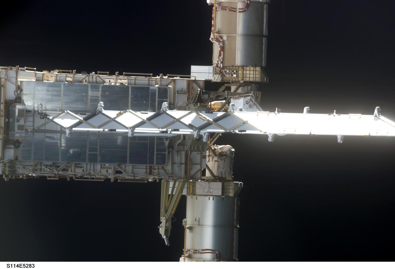 STS114-E-5283 (28 July 2005) --- This frame and STS114-E-5282 actually can be conjoined and rotated 90 degrees to make a single frame, providing an "astronaut's eye view" from Discovery's aft cabin looking toward the recently docked International Space Station.  This frame shows the end of the P6 truss and a radiator panel.  The two cropped cylinder-shaped objects are actually the base for the large solar array panels (out of frame).