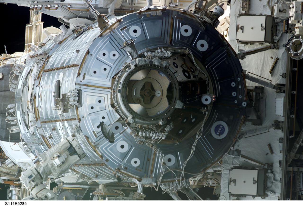 STS114-E-5285 (28 July 2005) --- One of the STS-114 crew members aimed a digital still camera through one of Discovery's aft cabin windows to capture this image of the U.S. Lab, Destiny. The International Space Station and Discovery had earlier joined together in space, as the joint activities of the STS-114 astronauts and the Expedition 11 crew members, still in separate spacecraft, work toward common goals.
