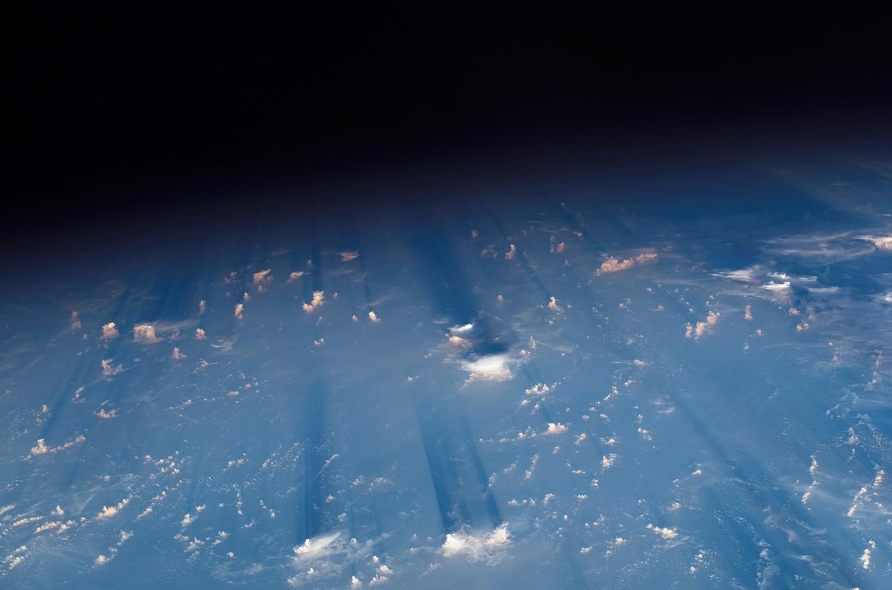 S114-E-5496 (28 July 2005) --- Earth&#0146;s limb at sunset as photographed by one of the STS-114 crewmembers through a window on the Space Shuttle Discovery. Beneath the limb, a blue and white Earth is visible.
