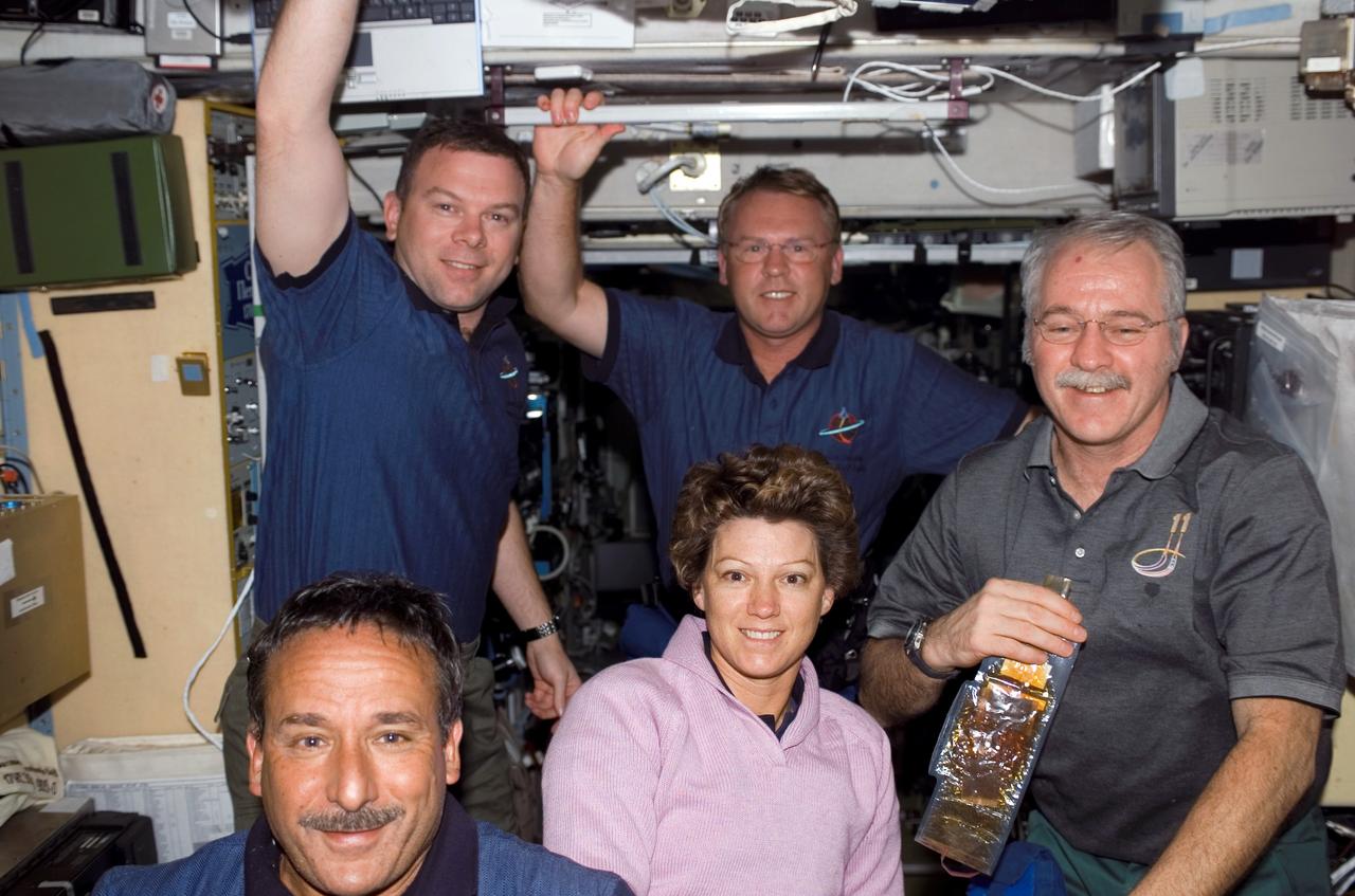 S114-E-5578 (28 July 2005) --- This is a rare scene of relaxation onboard the International Space Station as compared to the expected norm over the next several days when these astronauts and cosmonauts will be working jointly to perform a variegated lists of tasks. In front, from the left,  are astronaut Charles J. Camarda, STS-114 mission specialist; astronaut Eileen M. Collins, STS-114 commander; and astronaut John L. Phillips, NASA Space Station Science Officer and flight engineer for Expedition 11. Standing behind them are astronauts James M. Kelly (left), STS-114 pilot; and astronaut Andrew S.W. Thomas,  STS-114 mission specialist.
