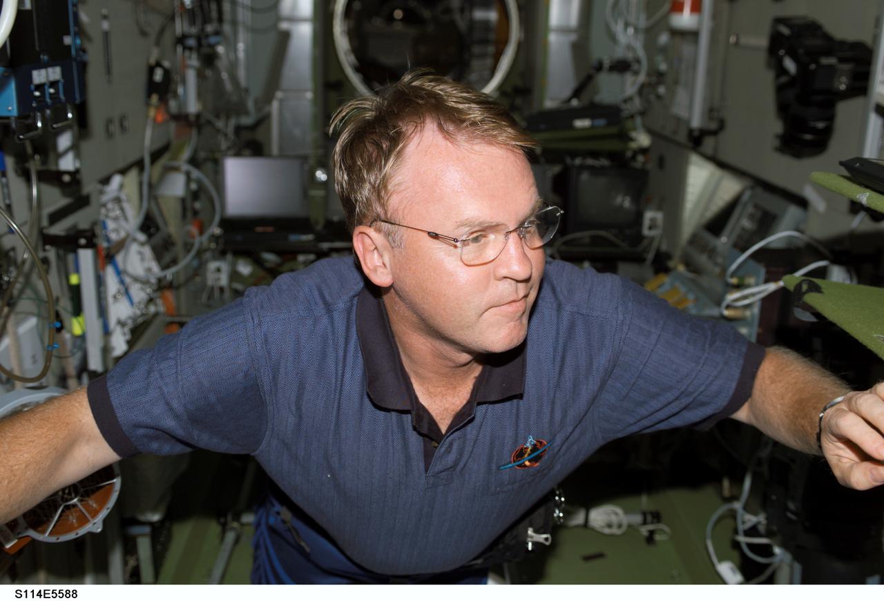 S114-E-5588 (28 July 2005) --- Astronaut Andrew S.W. Thomas may be reminiscing about his long duration stay aboard Russia's late Mir space station as he floats about the International Space Station during STS-114 flight day three activities.