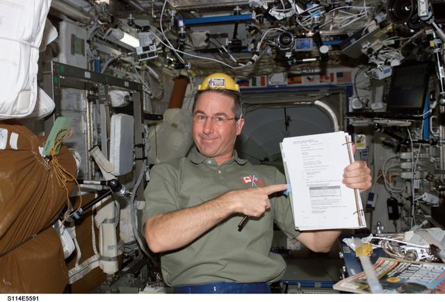 NASA image: Robinson in Destiny laboratory module wearing yellow hard hat
