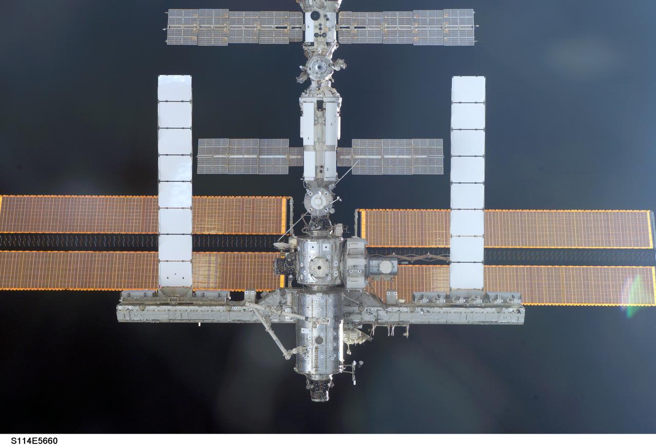 S114-E-5660 (28 July 2005) --- This image of the International Space Station easing toward the Space Shuttle Discovery was photographed by one of the STS-114 astronauts in the orbiter's crew cabin.