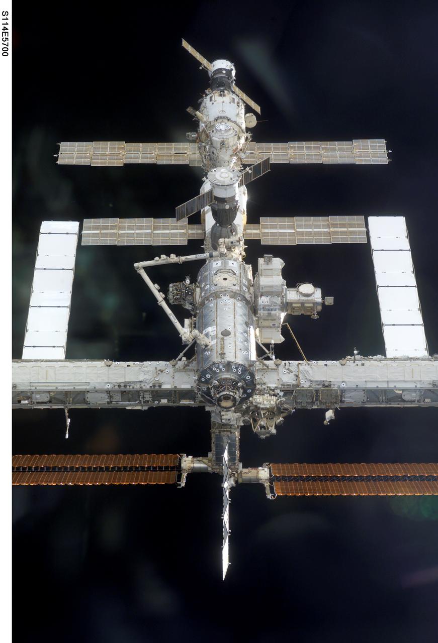 S114-E-5700 (28 July 2005) --- This image of the International Space Station easing toward the Space Shuttle Discovery was photographed by one of the STS-114 astronauts in the orbiter's crew cabin.