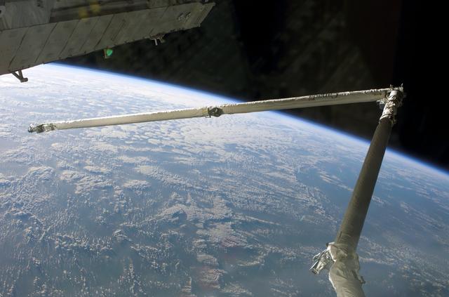 NASA image: Orbital Boom Sensor System with a cloudy Earth limb