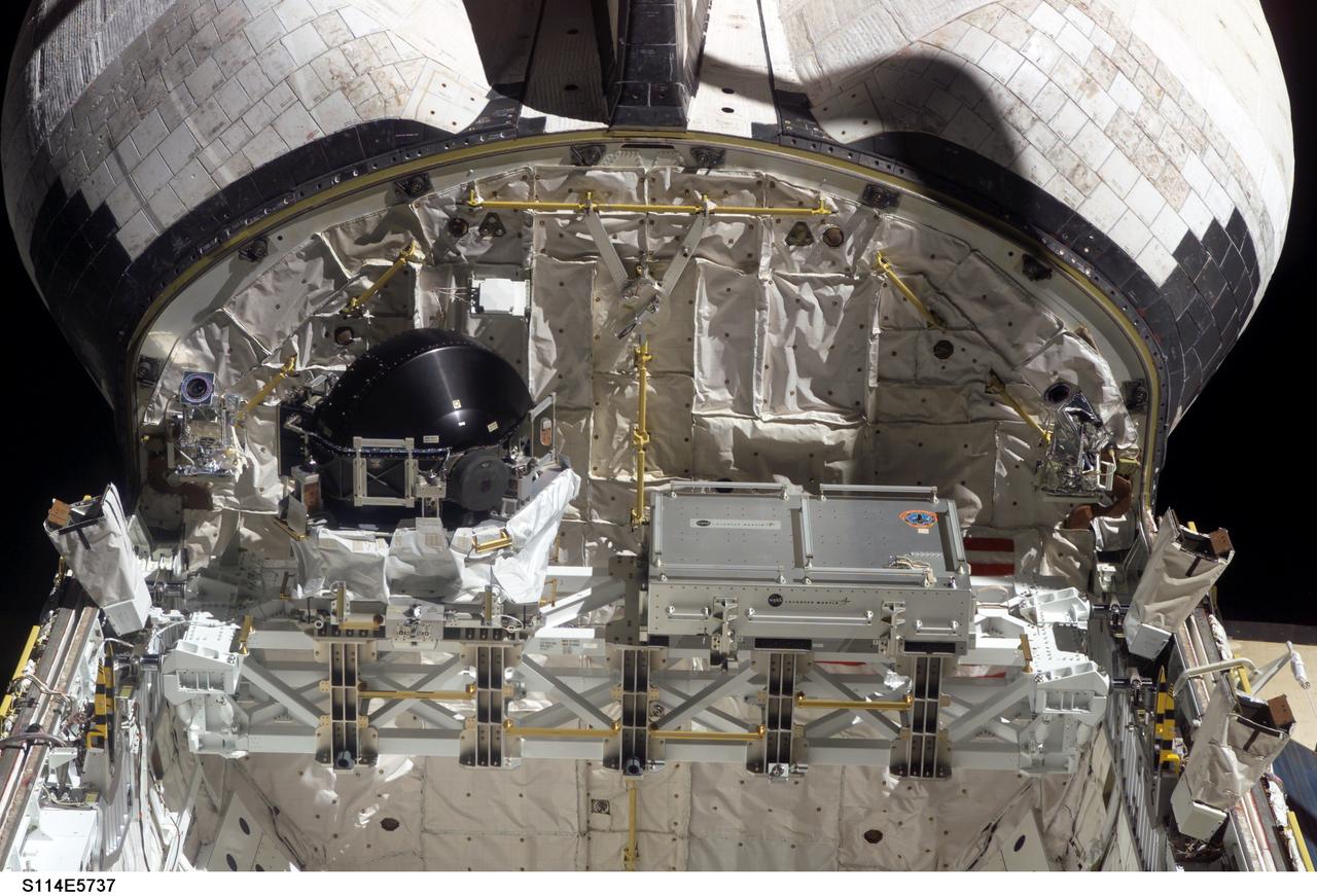 S114-E-5737 (29 July 2005) --- This high angle view of the aft end of Discovery's cargo bay in Earth orbit was taken from the International Space Station to which the Space Shuttle was docked at the time. The control moment gyro (CMG) replacement article, to be installed on an upcoming space walk, is on the left side of the frame.