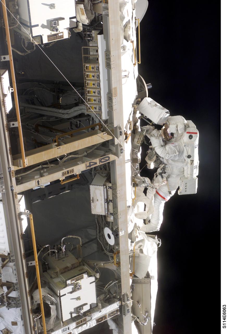 S114-E-6063 (30 July 2005) --- Astronaut Soichi Noguchi, STS-114 mission specialist representing Japan Aerospace Exploration Agency (JAXA), participates in the mission&#0146;s first scheduled session of extravehicular activity (EVA). Noguchi and crewmate Stephen K. Robinson (out of frame) completed a demonstration of Shuttle thermal protection repair techniques and enhancements to the International Space Station&#0146;s attitude control system during the successful 6-hour, 50-minute spacewalk.