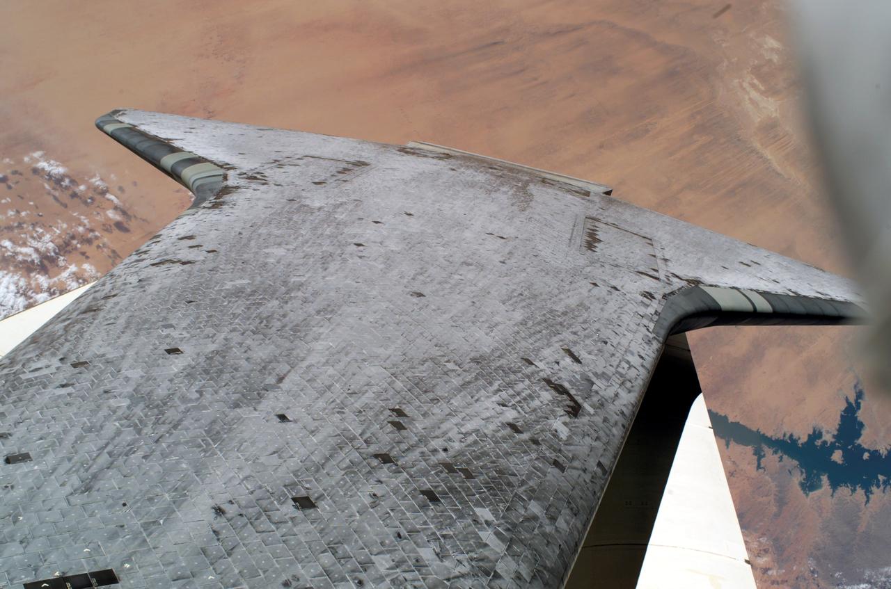 S114-E-6396 (3 August 2005) --- Space Shuttle Discovery&#0146;s underside thermal protection tiles are featured in this image photographed by astronaut Stephen K. Robinson, STS-114 mission specialist, during the mission&#0146;s third session of extravehicular activities (EVA). Lake Nasser along the Nile River, Egypt is visible near Discovery&#0146;s starboard wing.