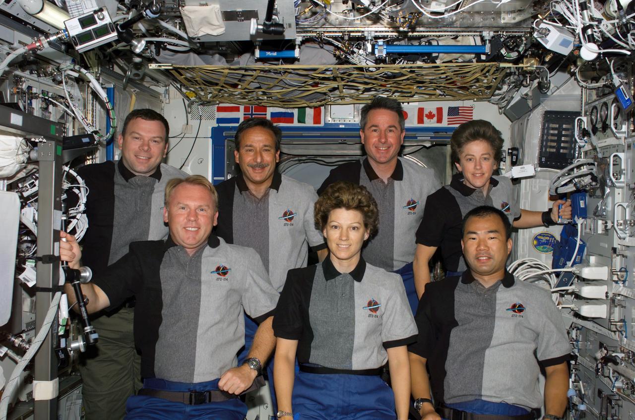 S114-E-6730 (2 August 2005) --- The STS-114 crewmembers pose for their traditional in-flight crew portrait in the Destiny laboratory of the international space station. From the left (front row) are astronauts Andrew S. W. Thomas, mission specialist; Eileen M. Collins, commander; and Soichi Noguchi, mission specialist representing the Japan Aerospace Exploration Agency (JAXA). From the left (back row) are astronauts James M. Kelly, pilot; Charles J. Camarda, Stephen K. Robinson, and Wendy B. Lawrence, all mission specialists.