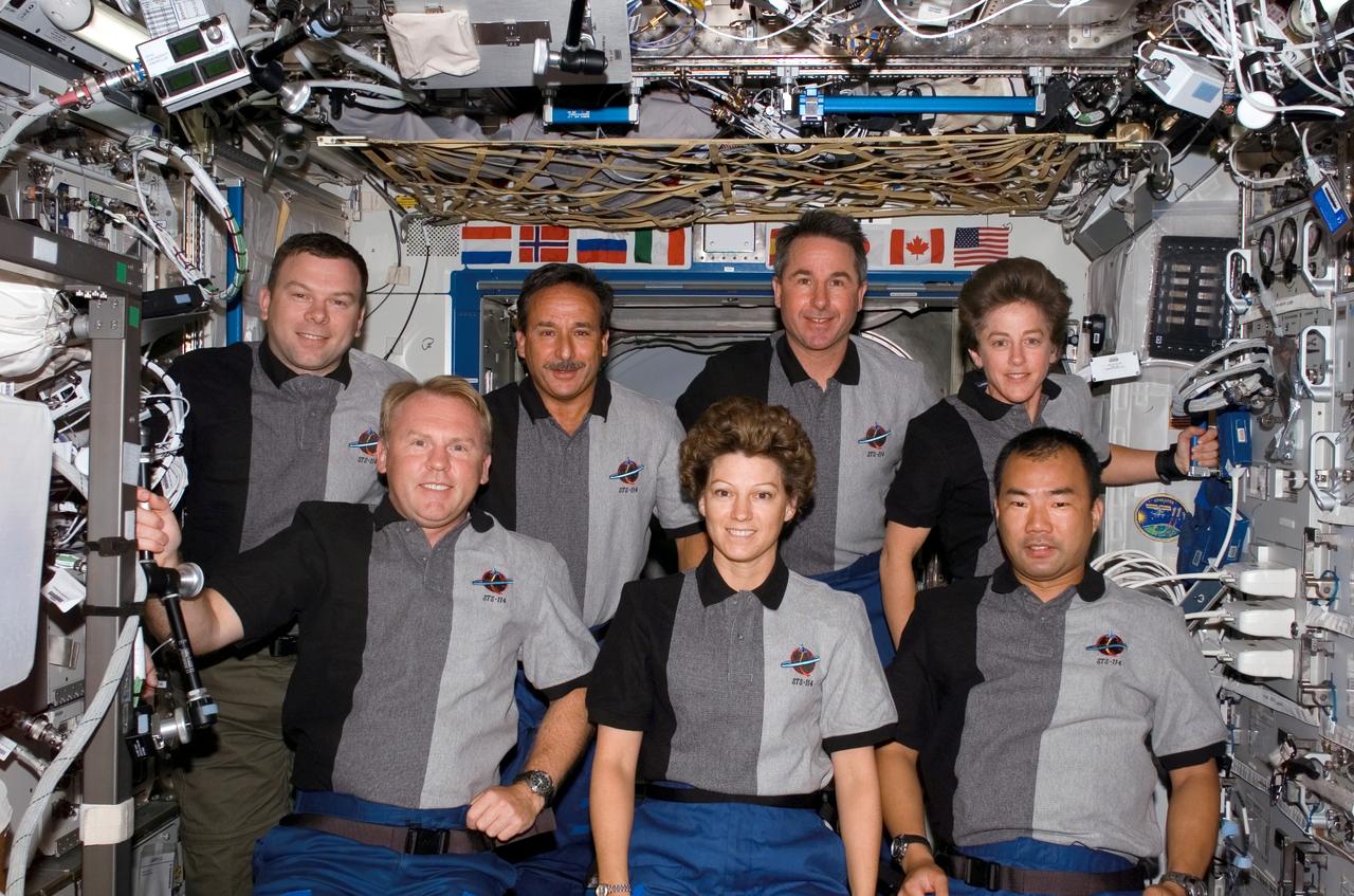 S114-E-6751 (2 August 2005) --- The STS-114 crewmembers pose for an in-flight portrait in the Destiny laboratory of the International Space Station. From the left (front row) are astronauts Andrew S. W. Thomas, mission specialist; Eileen M. Collins, commander; and Soichi Noguchi, mission specialist representing Japan Aerospace Exploration Agency (JAXA). From the left (back row) are astronauts James M. Kelly, pilot; Charles J. Camarda, Stephen K. Robinson, and Wendy B. Lawrence, all mission specialists.