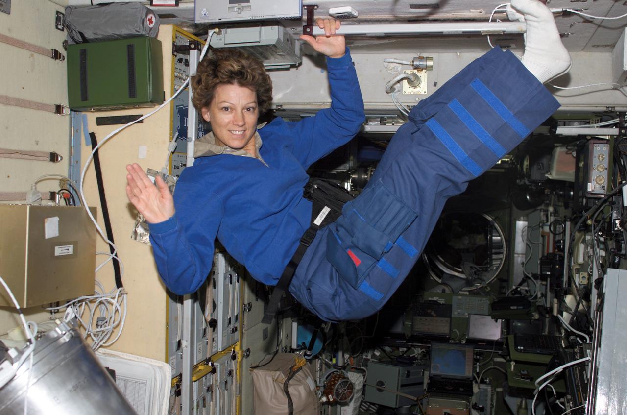 S114-E-7138 (5 August 2005) --- Astronaut Eileen M. Collins, STS-114 commander, waves while floating in the Zvezda Service Module of the international space station while Space Shuttle Discovery was docked to the station.