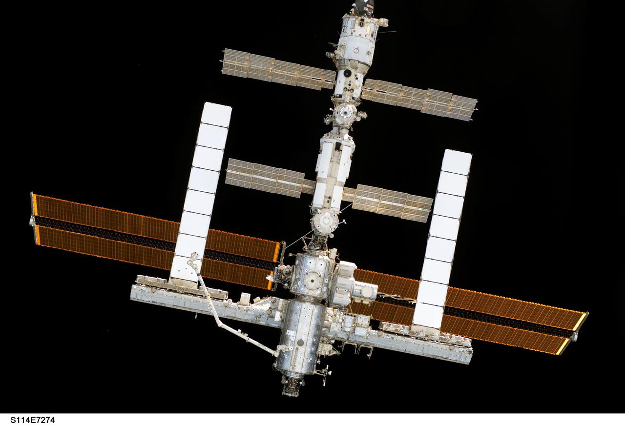 S114-E-7274 (6 August 2005) ---  The International Space Station and the  Space Shuttle Discovery begin their relative separation after their crewmembers concluded nine days of cooperative work. Undocking occurred at 2:24 a.m. (CDT), August 6, 2005.