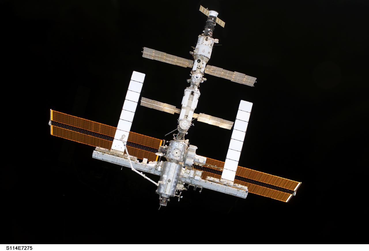 S114-E-7275 (6 August 2005) ---  The International Space Station is backdropped against blackness of space as the orbital outpost moves away from the Space Shuttle Discovery. Earlier, the crews of the two spacecraft concluded nine days of cooperative work. As the Shuttle moved away to a distance of about 400 feet, astronaut James M. Kelly, pilot, began a slow fly-around of the Station, while cameras on each spacecraft captured video and still images of the other. Undocking occurred at 2:24 a.m. (CDT), August 6, 2005.