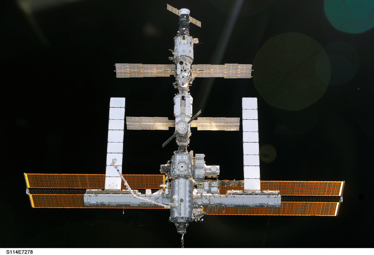 S114-E-7278 (6 August 2005) ---  The International Space Station is backdropped against the blackness of space as the orbital outpost moves away from the Space Shuttle Discovery. Earlier, the crews of the two spacecraft concluded nine days of cooperative work. As the Shuttle moved away to a distance of about 400 feet, astronaut James M. Kelly, pilot, began a slow fly-around of the Station, as cameras on each spacecraft captured video and still images of the other. Undocking occurred at 2:24 a.m. (CDT), August 6, 2005.