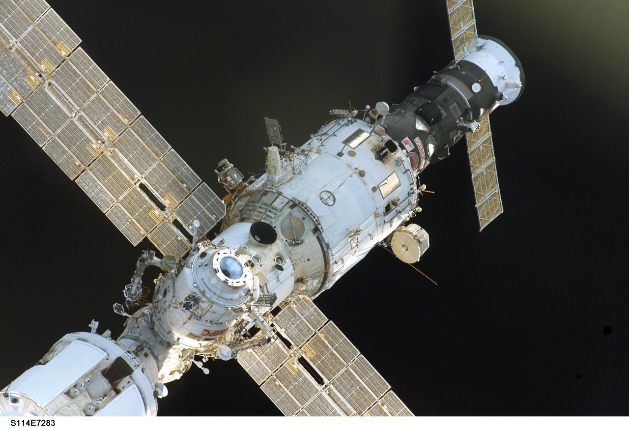 S114-E-7283 (6 August 2005) --- The International Space Station and the  Space Shuttle Discovery begin their relative separation after their crewmembers concluded nine days of cooperative work. Undocking occurred at 2:24 a.m. (CDT), August 6, 2005.