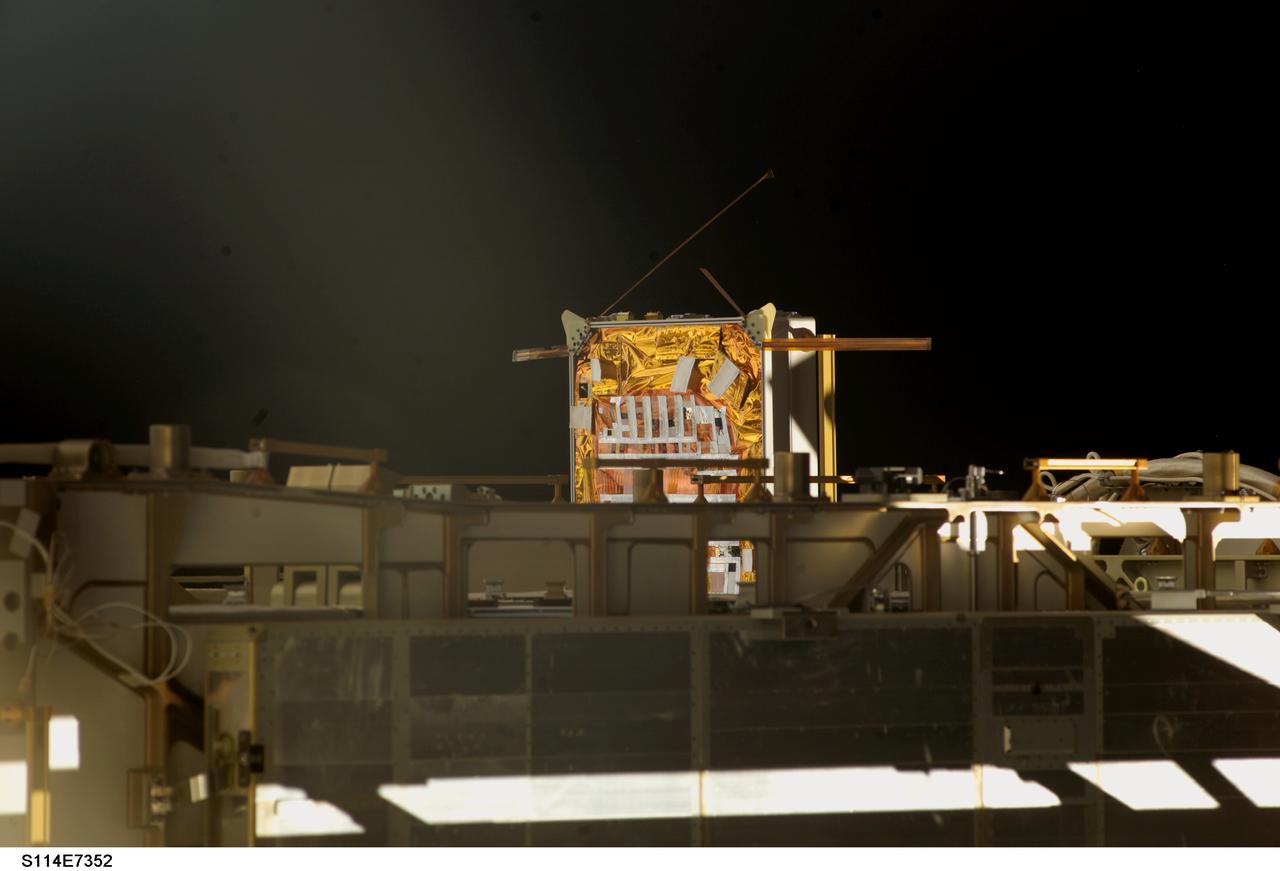 s114e7352 (8/6/2005) --- A view of the Materials International Space Station Experiment (MISSE) 5 Passive Experiment Containter (PEC) mounted on the P6 Truss during one of the STS-114 missions Extravehicular Activities (EVAs). The Materials International Space Station Experiment-5 (MISSE-5) was an external payload that flew on-board the ISS from August 2005 until September 2006. MISSE-5 provided an opportunity for researchers to test a wide range of samples in the Low Earth Orbit (LEO) environment.