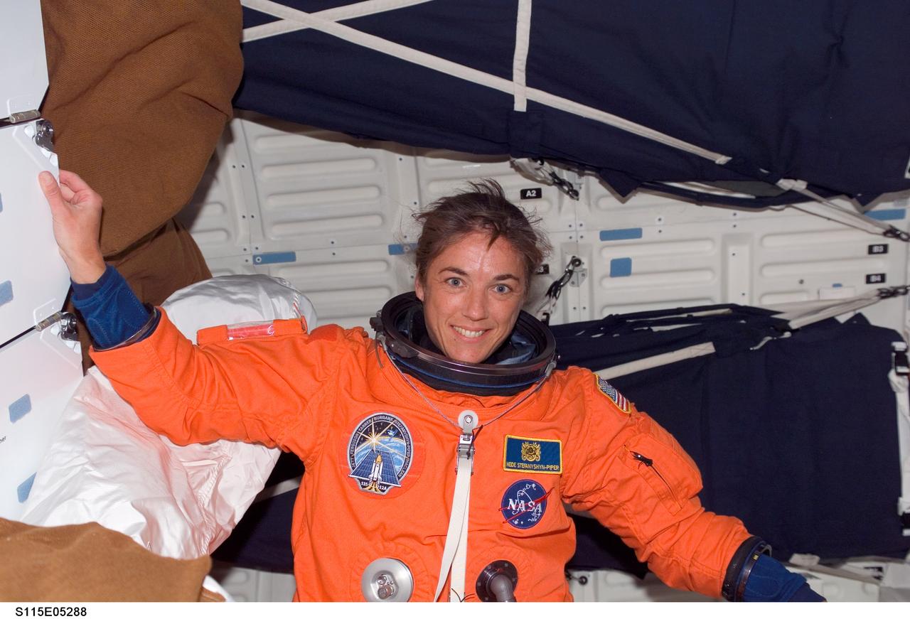 S115-E-05288 (9 Sept. 2006) --- Astronaut Heidemarie M. Stefanyshyn-Piper, STS-115 mission specialist, on mid deck of Atlantis before doffing her launch and entry suit.
